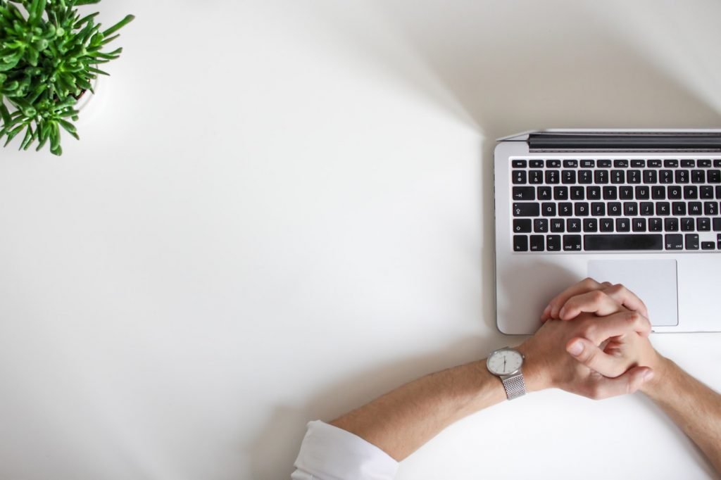 8 Effective Tips for Freelancers To Boost Your Inner Businessman 1 Freelance business person wearing watch near laptop: Tips for freelancers